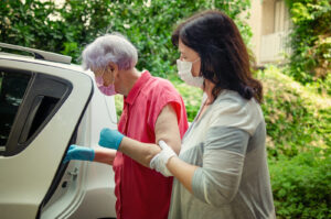 caregiver picking up elderly for doctor's appointment