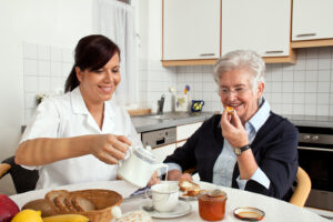caregiver serving elderly breakfast